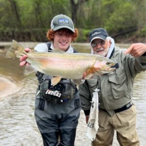 Ryan Peck and a client with a salt and pepper beard showing off a large fish